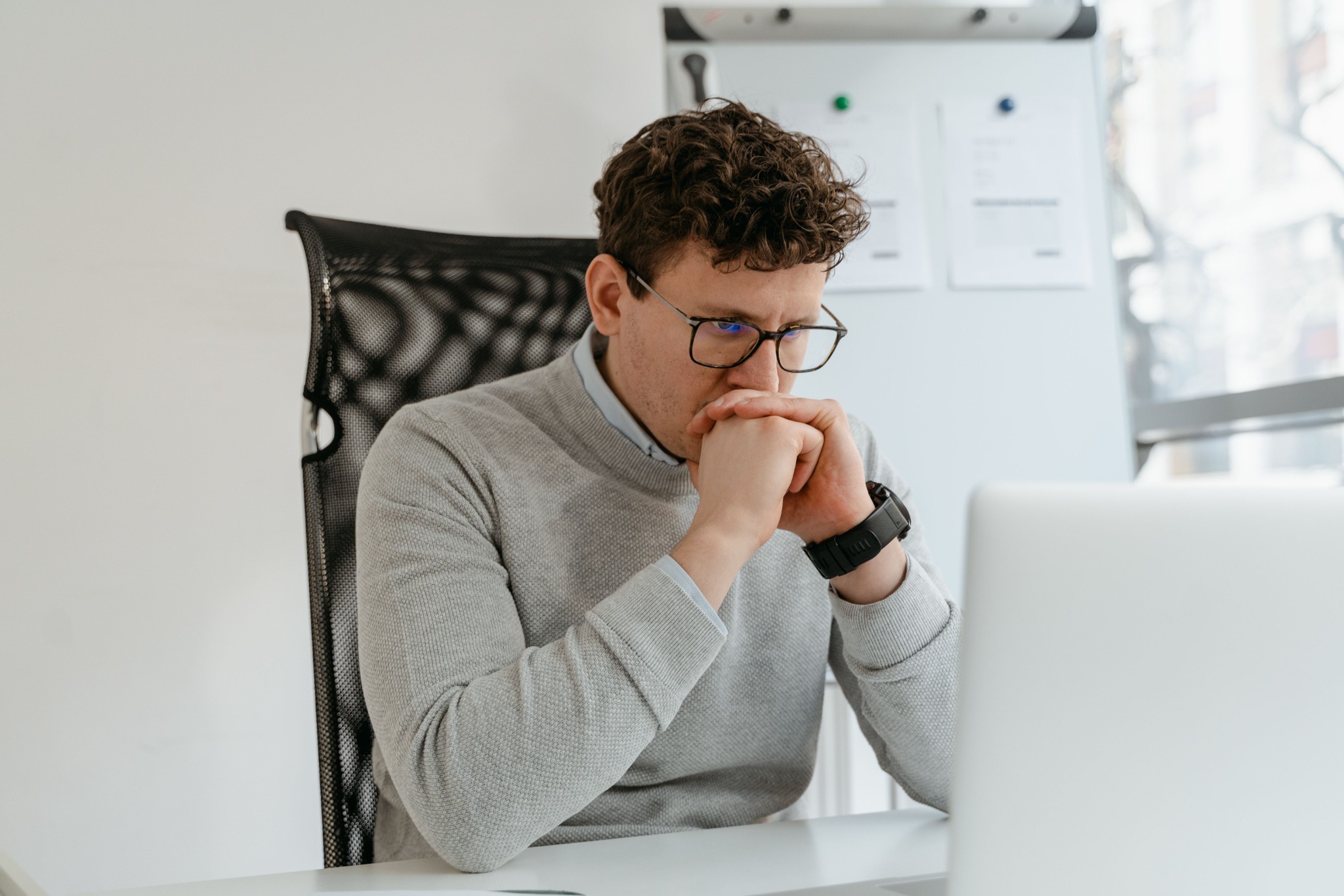 Business professional focused on a computer problem in an office